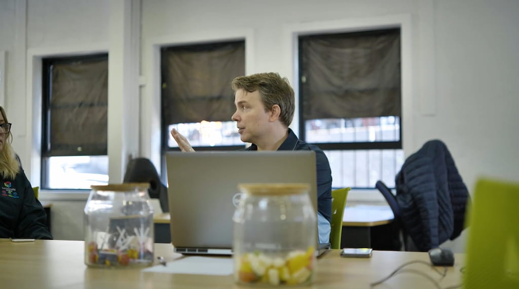 Two Ascora team members collaborating around a screen.