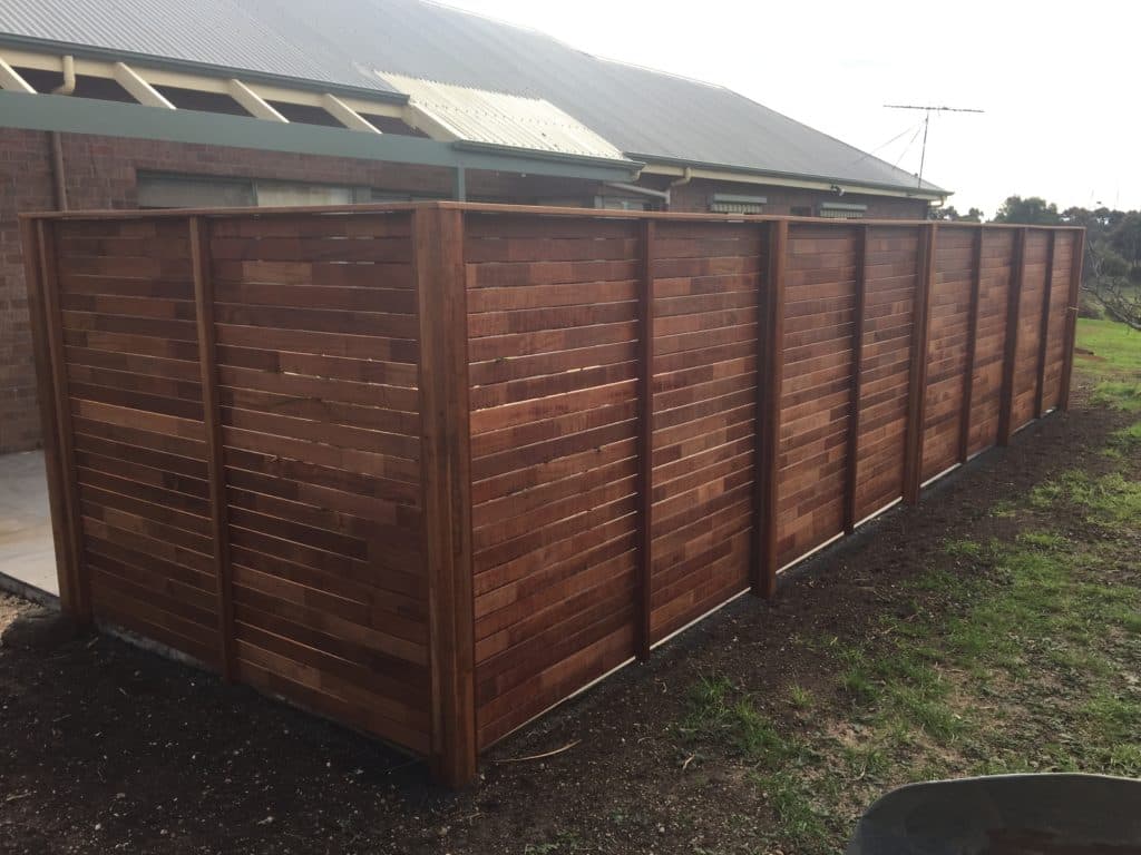 Carpenter at work on a wooden fence
